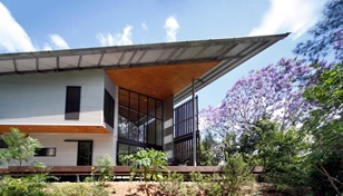 Far more than an esoteric gesture, the wide bladed roof performs as a broad-rimmed Akubra sheltering occupants from sun and storm.